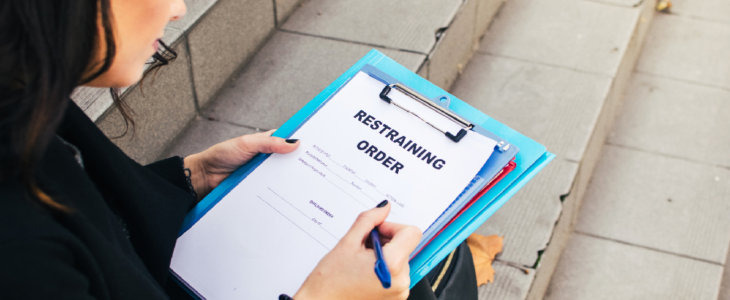 Woman filling out restraining order