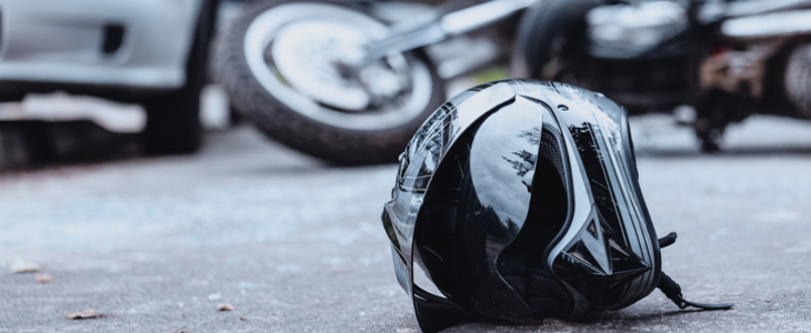 Helmet on the road from a motorcycle collision with a car