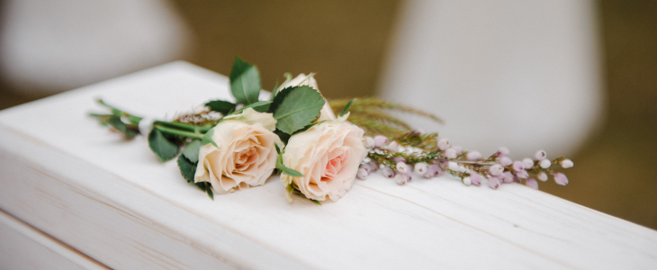 Rose sitting on top of a white casket