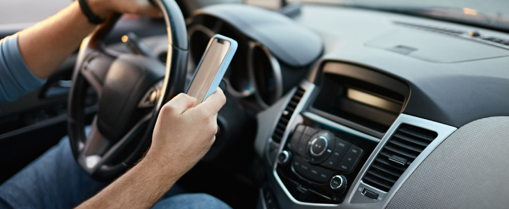 Man driving while on his phone