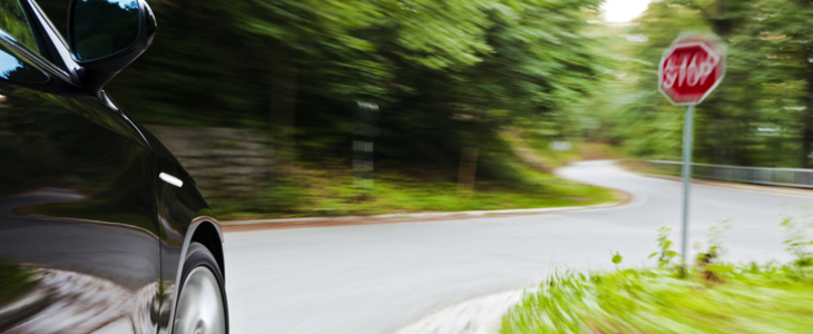 Car driving past stop sign