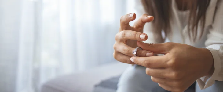 Woman taking off her ring due to an uncontested divorce